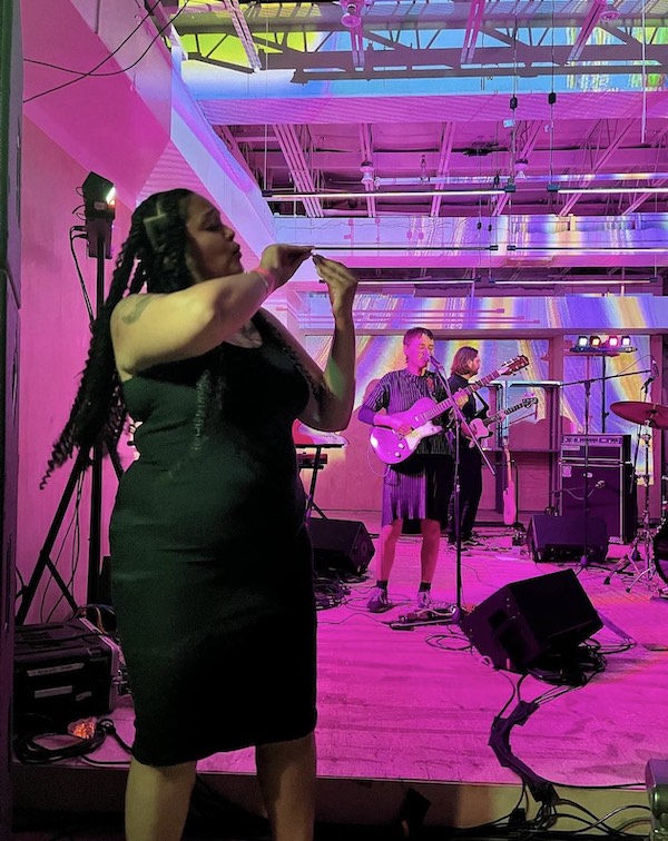 Gaitrie Persaud-Killings is shown performing ASL translation for a musical performance.