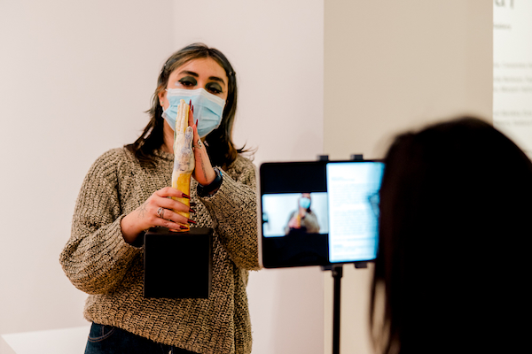 A gallery attendant providing an online tour through Tangled Art + Disability's #CripRitual exhibition.