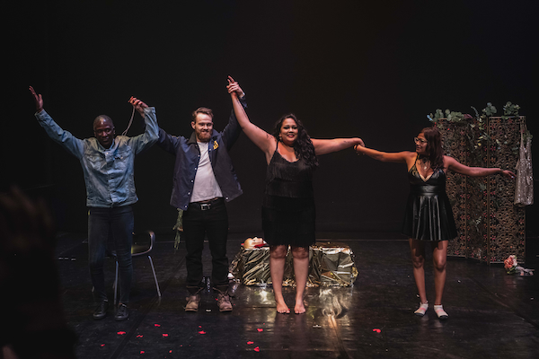Four actors on stage take a bow at the conclusion of the play.