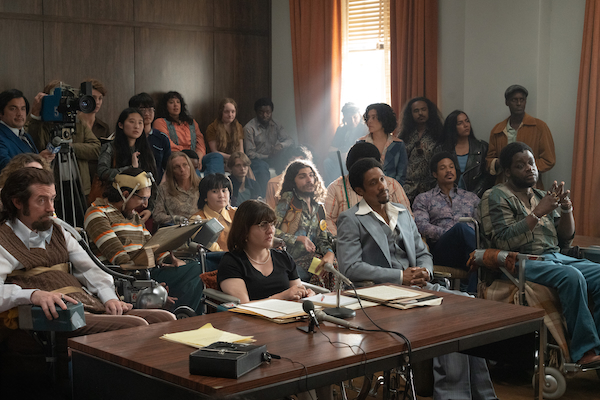A group of disabled activists are gathered in a government office to address a politician. This is a scene from the movie Being Heumann.