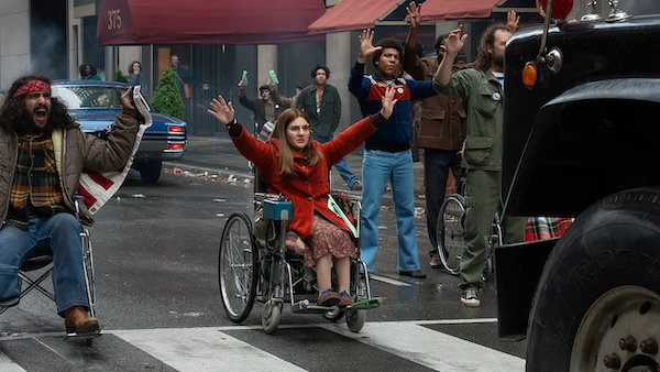 In a scene from the movie Being Heumann, the disability rights activist Judy Heumann is shown blocking a city street alongside other protesters.